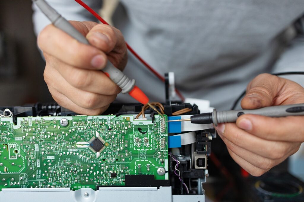 man-repairing-computer-part-in-service-