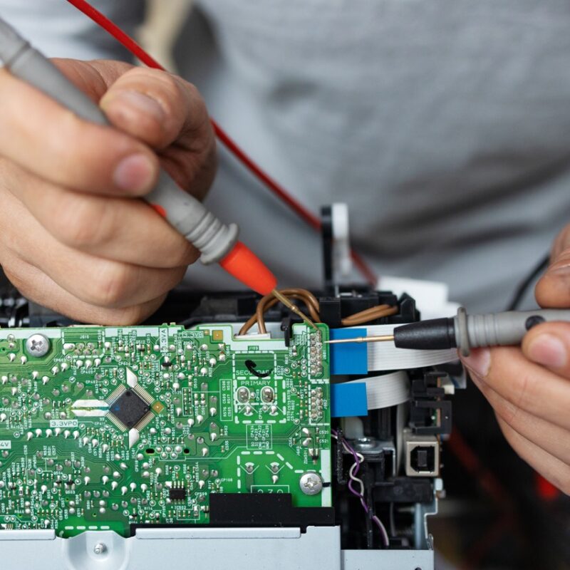 man-repairing-computer-part-in-service-